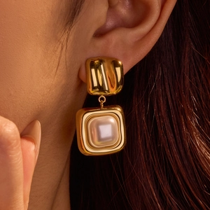 French vintage gold geometric square earrings with irregular pearls on a female model