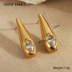 Gedetailleerde close-up van gouden druppeloorbellen met zirkonia in een elegante stijl