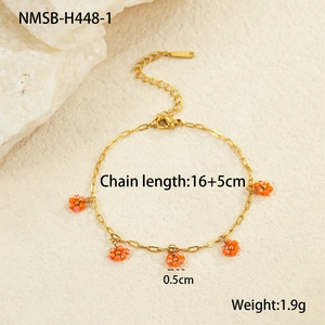 Detailed view of a gold chain bracelet with five orange beaded sunflower charms and size labels