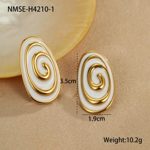 Detailed view of gold oval earrings with white enamel and spiral pattern with dimensions