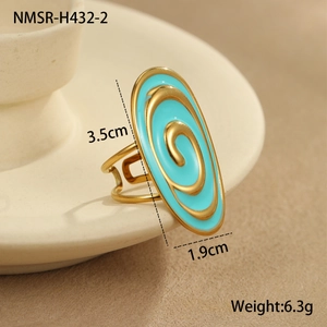 Detail view of oval enamel ring featuring golden spiral lines and turquoise blue finish