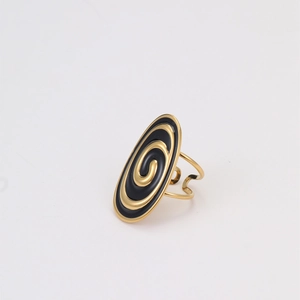 Detailed macro view of an adjustable gold ring with black enamel oval spiral pattern