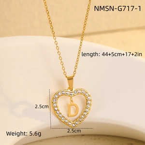 Detailed view of gold heart pendant with letter D and cubic zirconia setting measurement