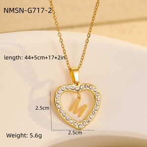 Close-up of 18K gold plated heart pendant with zircon frame and moving letter M