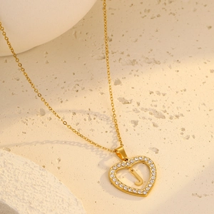 Detailed macro view of 18K gold plated heart pendant necklace with letter J and zircons