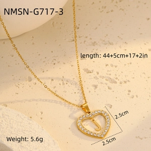 Macro shot of 18K gold plated heart pendant with zircon frame and letter J detail