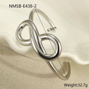 Macro detail of silver infinity symbol bracelet with mirror polished stainless steel surface