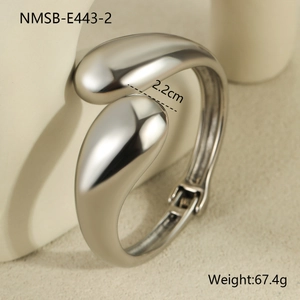 Macro view of silver geometric teardrop bangle with a smooth polished metallic finish