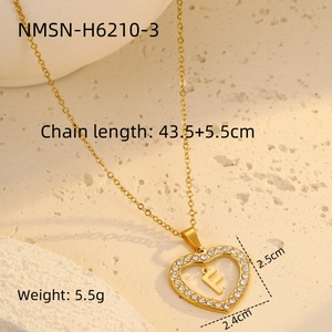 Detailed view of gold heart pendant with letter F and white zircon stones measurement
