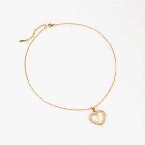 Detail of 18K gold plated heart necklace with letter J and shimmering cubic zirconia stones