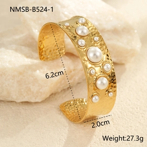 Détail du bracelet manchette doré en acier inoxydable avec perles et texture martelée