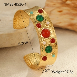 Détail d'un bracelet vintage en acier doré martelé avec pierres précieuses colorées