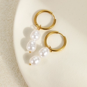 Detailed macro shot of elegant baroque irregular pearls on 18k gold earrings set
