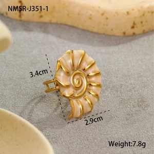 Macro detail of the 18K gold-plated nautilus shell ring with cream enamel inlay