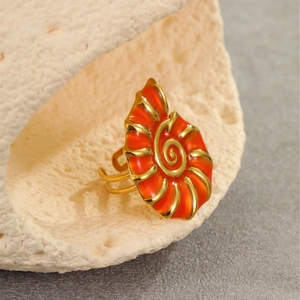 Macro shot of orange shell ring with gold trim and adjustable 18K gold plated band