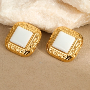 Detail von quadratischen Vintage-Ohrsteckern in Gold mit Inlay und Hammerschlag-Optik