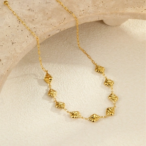 Détail du collier en acier inoxydable plaqué or 18k avec pendentifs coquillages sur pierre
