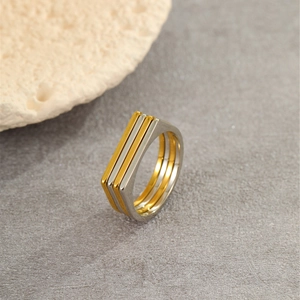 Detailed macro view of the two-tone gold and silver layered geometric gear ring