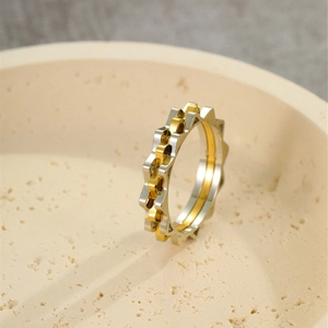 Minimalist two-tone gear design ring in polished gold and silver stainless steel