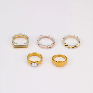 Detail showing assorted titanium steel rings with gear, wave, and pearl textures