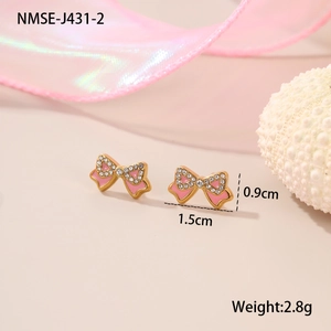 Detail of pink enamel bow stud earring with white crystal trim and gold base plating