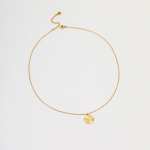 Detail of gold-plated stainless steel necklace showing radial texture on fan pendant