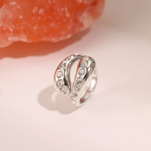 Macro shot of silver-tone open ring with double-row sparkling zircon stones on salt rock