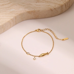 Detail view of 18k gold plated titanium bracelet with star pendant and zircon stones