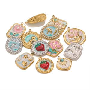 Detailed close-up of various floral and nature-themed stainless steel enamel pendants