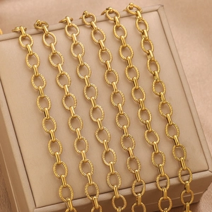 Detail of 18k gold plated stainless steel twisted chain on a beige jewelry case