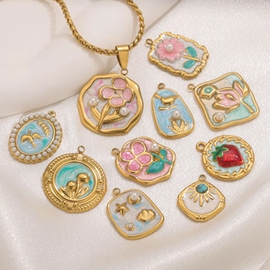 Macro view of vintage floral oil painting style pendants on soft silk fabric