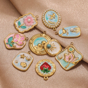 Macro detail of eight vintage enamel floral pendants on champagne silk background