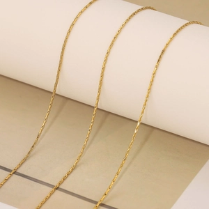 Macro view of 18k gold plated stainless steel snake chain showing smooth metallic texture