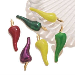 Macro shot of colorful enamel chili charms with gold loops for DIY jewelry making