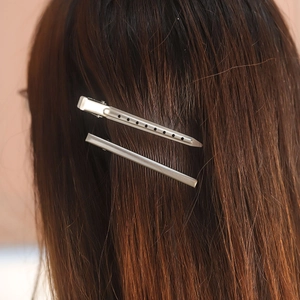 Stainless steel hair clip set for styling and salon sectioning on dark brown hair