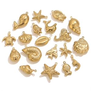 Macro view of gold PVD plated stainless steel ocean theme charms for jewelry DIY making