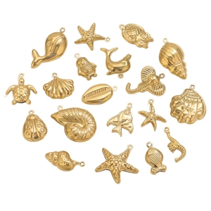 Collection of 18K gold-plated ocean-themed charms including shells, turtles, and seahorses