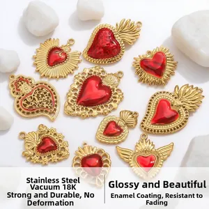 Detail of 18k gold plated heart pendants with red enamel and angel wings design