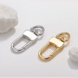 Close-up of polished stainless steel swivel lobster clasps in gold and silver finishes
