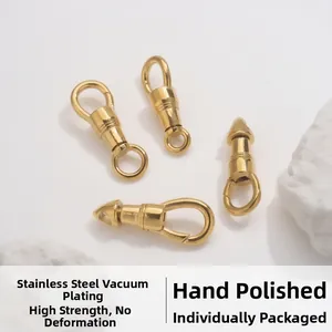 Detailed macro view of four polished gold stainless steel lobster swivel clasps on white