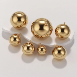 Polished gold vacuum plated stainless steel hollow ball pendants in various sizes