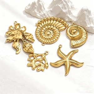 Five gold-plated ocean pendants featuring starfish and coral designs for DIY jewelry