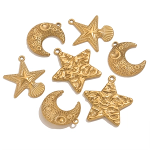 Detailed macro of gold plated stainless steel star and moon pendants for jewelry making