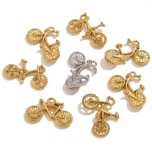 Detailed view of gold and silver vintage bicycle charms for DIY jewelry making