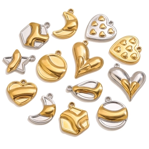 Macro detail of mixed gold and silver celestial pendants in heart and moon shapes