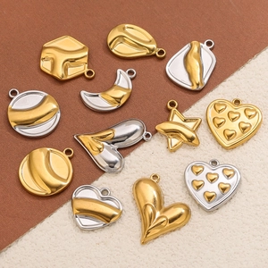 Macro shot of assorted gold and silver stainless steel pendants for DIY jewelry making