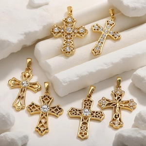 Variety of 18k gold plated stainless steel cross pendants with zircon on white stone