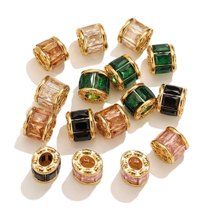 Macro detail of 18k gold plated spacer beads with micro-paved baguette crystals and engravings