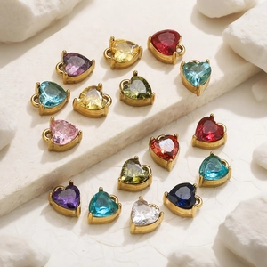 Detailed close-up of heart-shaped multi-color crystal pendants with gold metal settings