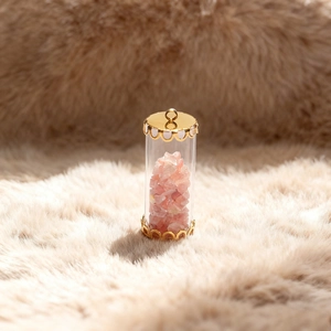 DIY necklace pendant featuring clear glass tube filled with natural pink quartz stone